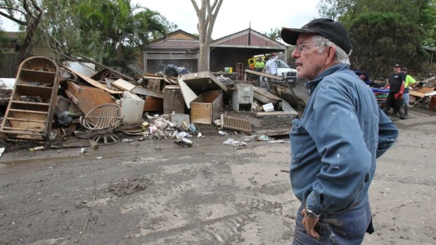 Volunteer truck driver Paul Eadie surveys the rubbish in Brisbane in 2011.