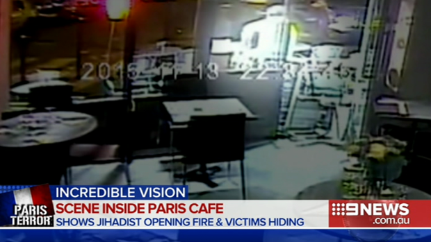 The gunman - seen as a white figure - outside the pizzeria in a screengrab from the CCTV footage.