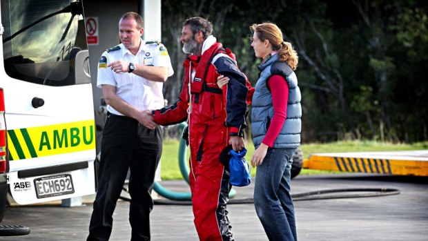 Cold comfort: Sarah Donaldson helps her husband Scott from the Taranaki Rescue Helicopter after he called it quits on his quest to kayak the Tasman Sea.