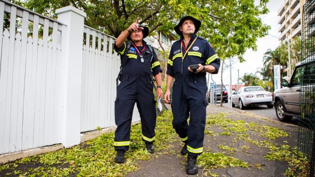 QFRS station officers Stewart Lange and Kerry Weir survey damage in Spring Hill after the Brisbane storm.