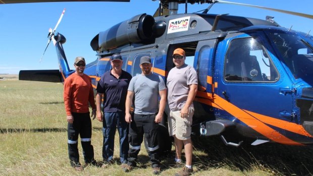 Brandon Hahaj, Fergus Frater, Brian Jorgenson and Brady Schaures stand in front of the UH60A Black Hawk at Goulburn airport, on standby to assist the fire in Tarago. 