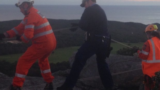 SES volunteers and police work to rescue the boy trapped at Monkey Rock.