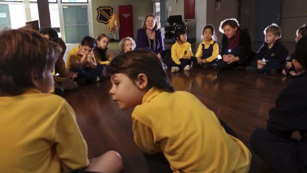 Ethics teachers Jane Morris and Carol Connolly talk with kindergarten students at Haberfield Public School.