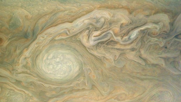 This enhanced colour view of Jupiter's cloud tops was processed by citizen scientist Bjorn Jonsson using data from NASA's Juno spacecraft. The image highlights a massive counterclockwise rotating storm that appears as a white oval in the gas giant's southern hemisphere. 
