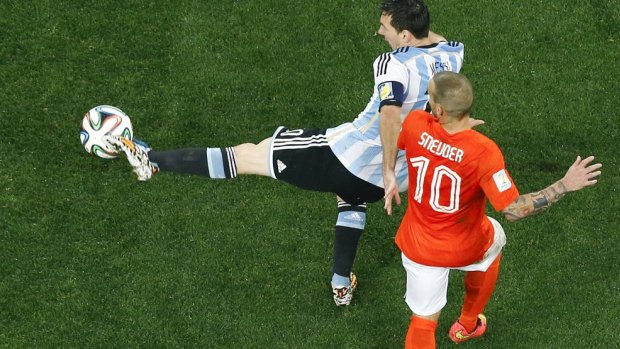 Argentina's Lionel Messi is challenged by Netherlands' Wesley Sneijder.