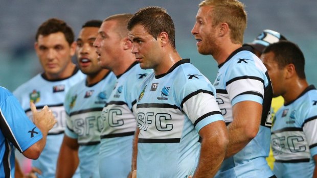 Cronulla players in an all-too-familiar pose, watching a Bulldogs conversion attempt.
