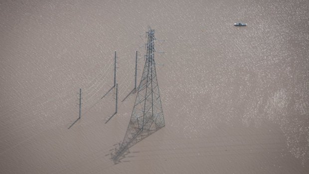 Power lines under water west of Ipswich during the flood.
