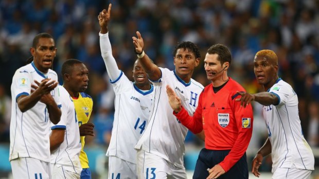 The Honduras players appeal to Australian referee Benjamin Williams just before half-time.