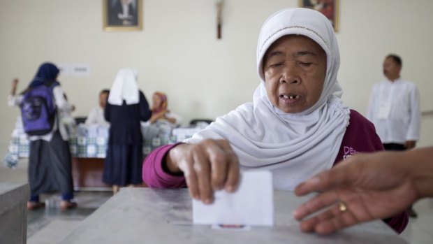 A Muslim woman casts her ballot at a polling station in a Catholic hospital in Yogyakarta. 