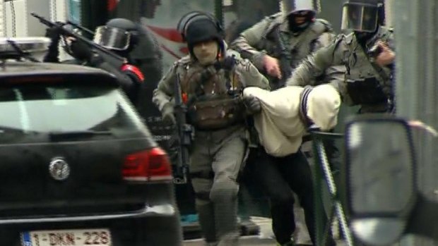 Armed police officers arrested Salah Abdeslam during a raid in the Molenbeek neighborhood of Brussels in March 2016.