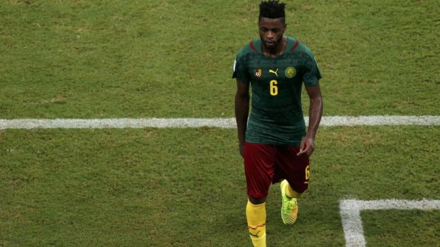 Cameroon's Alex Song walks off the pitch after his red card.
