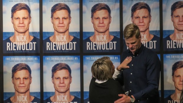 Nick Riewoldt is congratulated by his mother at his book launch.