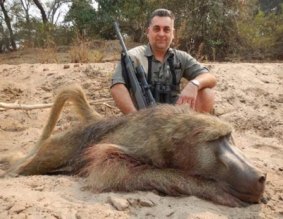 Nick Haridemos with the same baboon killed on a hunting trip to Zimbabwe in 2014.