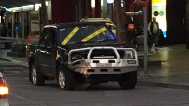 The car can be seen at the corner of Bourke and Swanston streets after the crash.