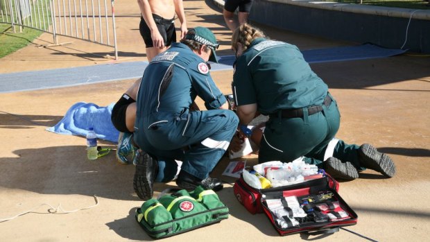 Paramedics treat a woman after allegedly being hit by a drone.