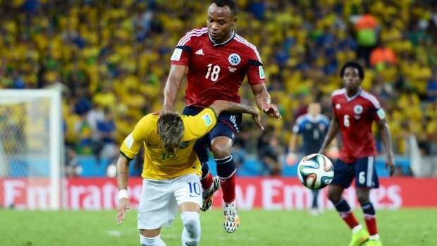 No ordinary challenge: Juan Zuniga's knee hits Neymar in the back.