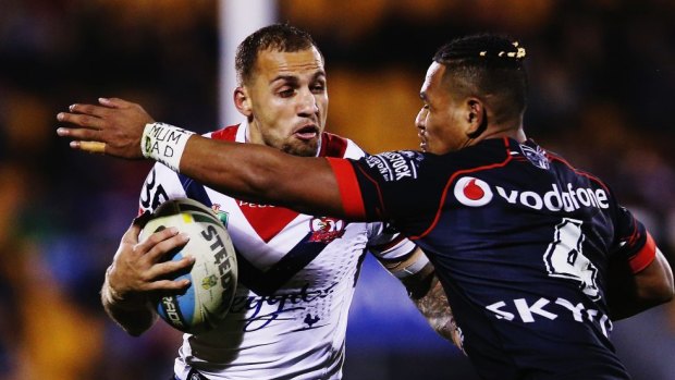 The Roosters' Blake Ferguson fends off Solomone Kata of the Warriors last month.