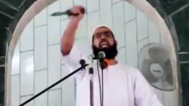 Muhammad Sallah brandishes a knife during a Friday sermon at al-Abrar mosque in the Gaza Strip town of Rafah on October 9.  