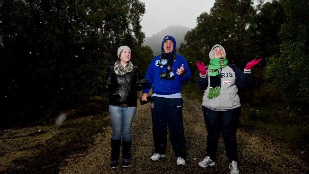 Enjoying the snow near Corin Forest  (l-r) Amy, Craig and Fiona Gilmore of Isabella Plains.