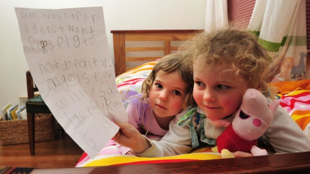  Peppa Pig fan, Tess Coventry, 5 with the letter that she wrote to the paper hoping that Peppa Pig wouldn't be taken from her tv because her sister India, 2 1/2 would be sad. 