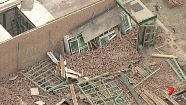 A worker was killed when a wall collapsed during high winds in Carlingford.