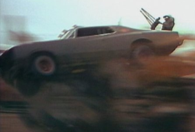 Max Aspin doubled for Mel Gibson in the 1981 film. Here, he crashes a modified Valiant Regal in a stunt that did not go to plan. 