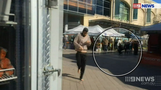 Alleged knife attacker Jerry Sourian at Westfield Hornsby with an injured bystander in the background.