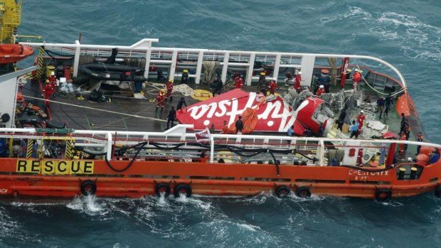 The tail of AirAsia QZ8501 passenger plane on the deck of the Indonesian Search and Rescue ship Crest Onyx after it was lifted from the sea bed, south of Pangkalan Bun, Central Kalimantan. 