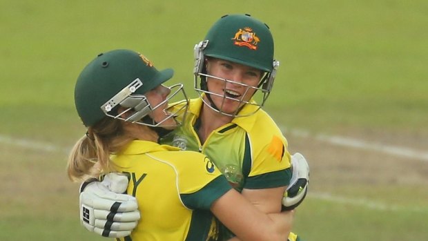 Top gun: Jess Cameron (right) with Ellyse Perry after winning the women's World Twenty20 title in 2014.