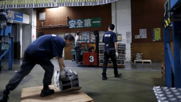An employee operates a forklift to transport a pallet stacked with bundles of the Apple Daily newspaper, published by Next Media, at the company's printing facility in Hong Kong.