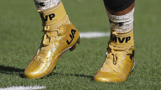 Gold standard: Cam Newton sports the customised Under Armour cleats during the warm-up at Super Bowl 50.