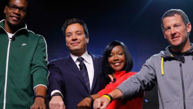 NBA star Kevin Durant, TV show host Jimmy Fallon, track star Carmelita Jeter and cycling celebrity Lance Armstrong, all shown wearing the Nike FuelBand on January 19, 2012.