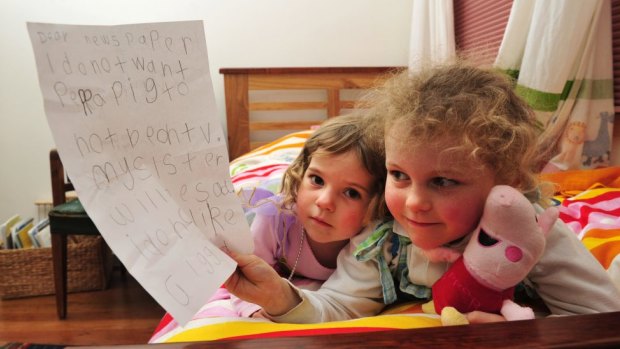 Peppa Pig fan Tess Coventry, 5, with the letter she wrote calling for the popular children's TV show to stay on the ABC for her sister India, 2.