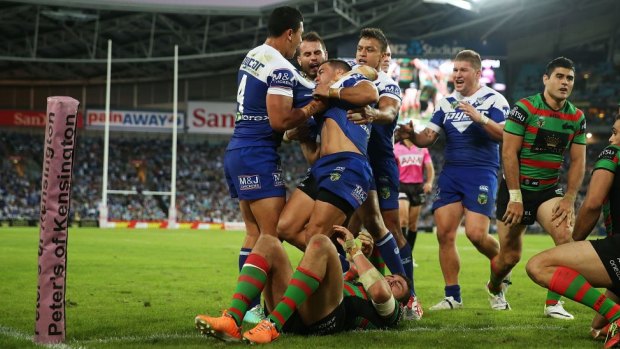 Controversial: The Bulldogs celebrate their hotly contested try against Souths.