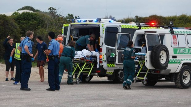 Emergency workers including Esperance St John Ambulance community paramedic Paul Gaughan try to save shark attack victim Laeticia Brouwer on Monday. 