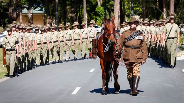 A riderless horse, symbolising a fallen soldier leads the funeral procession for Trooper Stuart Reddan in Buderim.