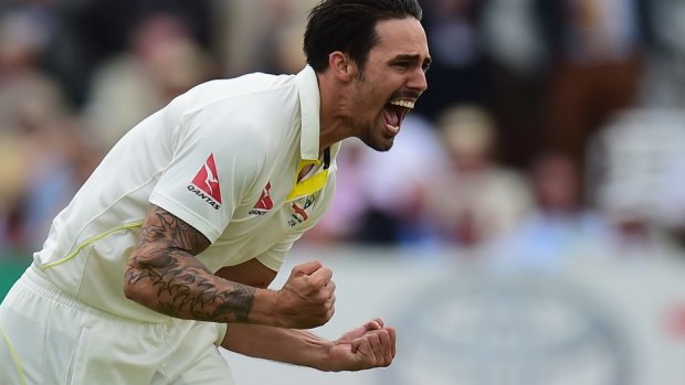 Mitchell Johnson celebrates after taking the wicket of Joe Root of England.