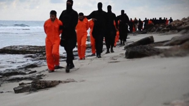 Men purported to be Egyptian Christians held captive by the Islamic State are marched by armed men in this still image from the video.