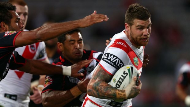 Dragons fullback Josh Dugan escapes the clutches of the Warriors' defence.