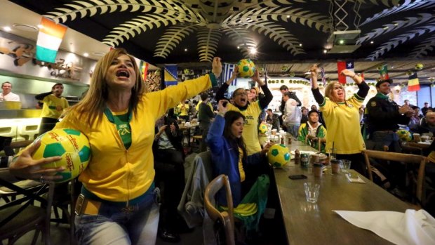 Football fever: Brazilian supporters watch their team at,  Braza Churrascaria Bar, Darling Harbour.