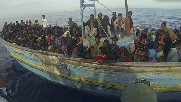 Migrants sit in their boat during a rescue operation off the coast of Sicily earlier this month. 
