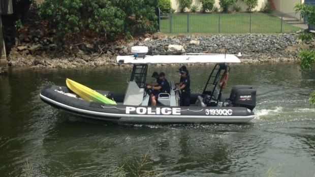 Gold Coast water police with a kayak found in the canal.