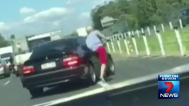 A Bargara man is filmed punching a car in an apparent road rage attack on the Bruce Highway at Burpengary.