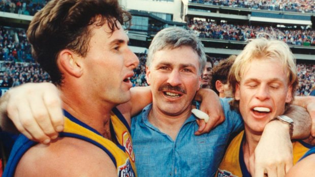 Brett Heady, Dean Kemp and Mick Malthouse and embrace after West Coast's 1992 premiership win.