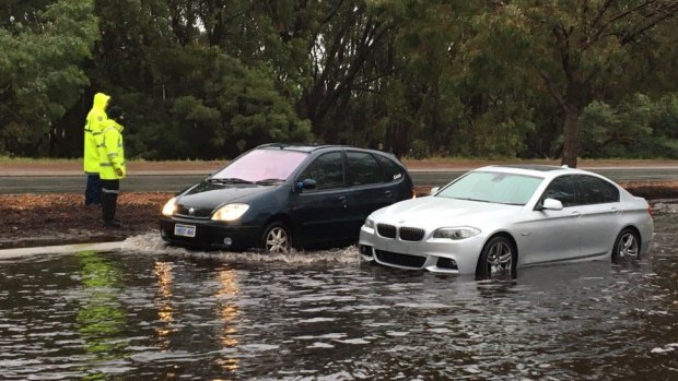 A BMW trapped in flood waters in Osborne Park on Friday morning.