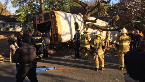 A school bus is wrapped around a tree at the scene of a crash in which multiple people have been reported dead in Chattanooga, Tennessee.