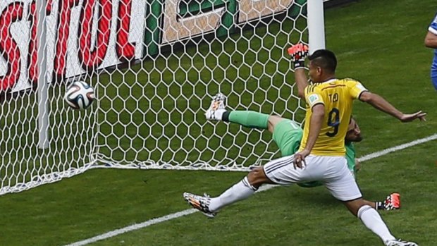 Colombia's Teofilo Gutierrez scores past Greece's goalkeeper Orestis Karnezis.
