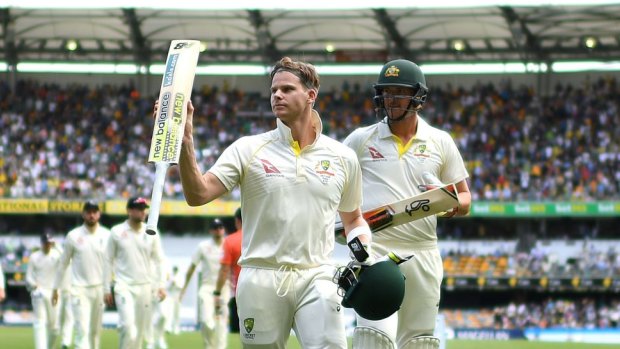 Rescue act: Steve Smith raises his bat to applause as he leaves the field at tea.