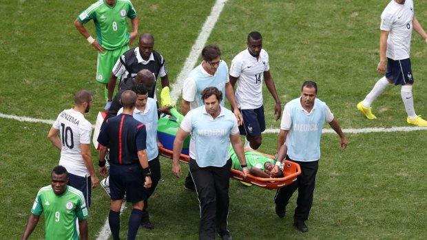 Ogenyi Onazi of Nigeria is stretchered off after a challenge by Blaise Matuidi.