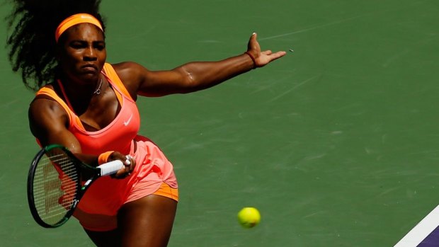 Serena Williams returns the ball against Carla Suarez Navarro.